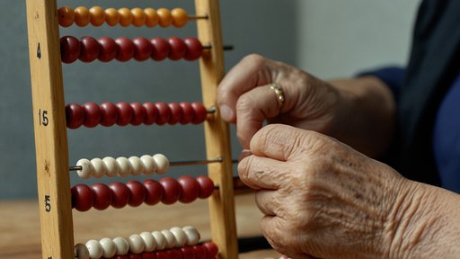 An Elderly Person Using An Abacus To Perform Calculati